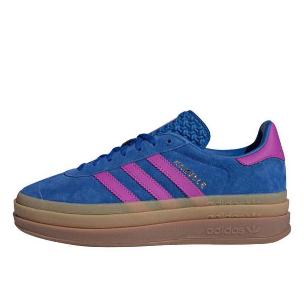 adidas Gazelle suede sneakers with stacked three-layer design, serrated 3-Stripes, and metallic-gold "Gazelle" logo.