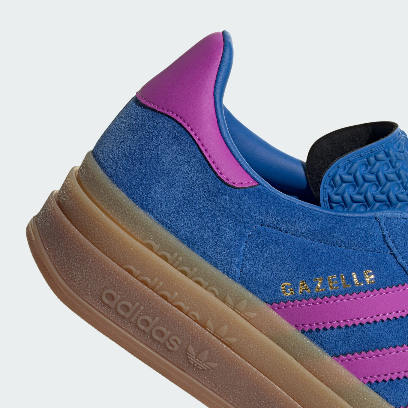 adidas Gazelle suede sneakers with stacked three-layer design, serrated 3-Stripes, and metallic-gold "Gazelle" logo.
