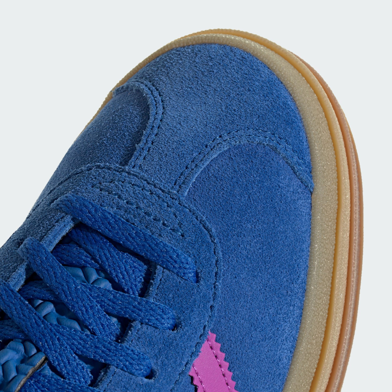 adidas Gazelle suede sneakers with stacked three-layer design, serrated 3-Stripes, and metallic-gold "Gazelle" logo.