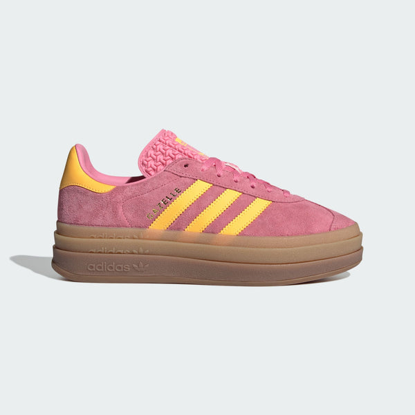 adidas Gazelle in buttery-soft suede with serrated 3-Stripes, stacked three-layer design, and metallic-gold "Gazelle" logo.