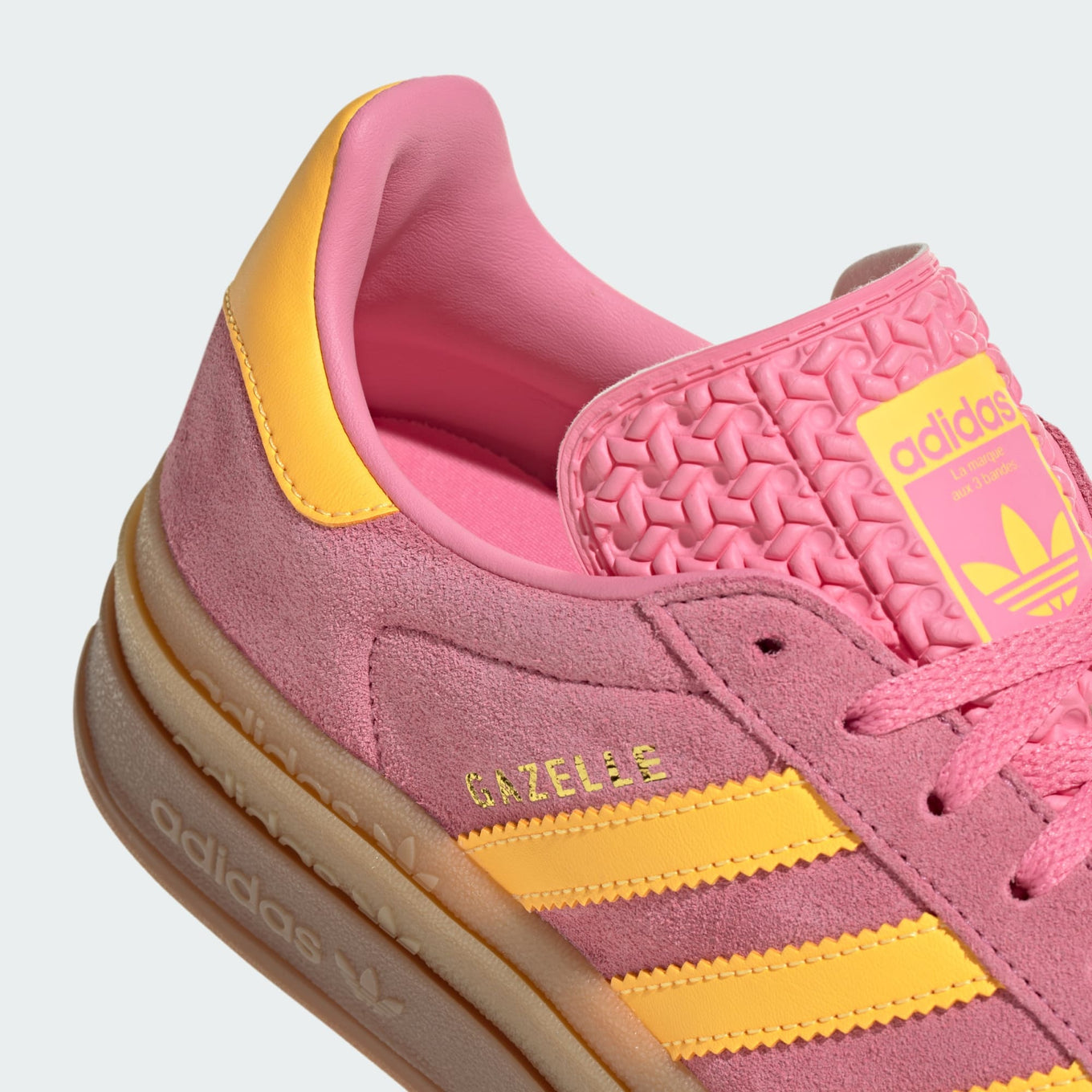 adidas Gazelle in buttery-soft suede with serrated 3-Stripes, stacked three-layer design, and metallic-gold "Gazelle" logo.