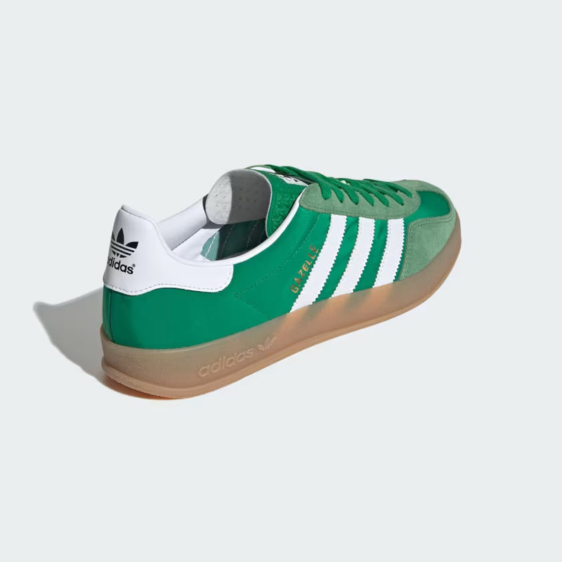 Close-up of The Gazelle Indoor shoes, showcasing their premium suede upper and gum rubber outsole. The design includes the iconic Trefoil logo and serrated 3-Stripes, blending contemporary style with a classic football training aesthetic.