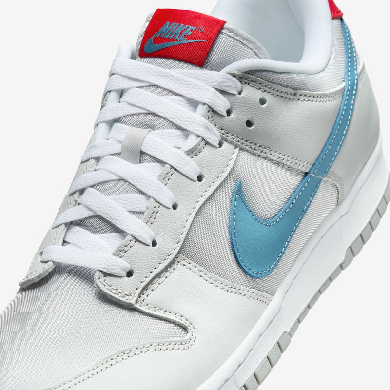 Nike Dunk silver superhero edition 20th anniversary with Flat Silver and Neutral Grey leather, airy textiles, Aegean Storm, and Gym Red accents.