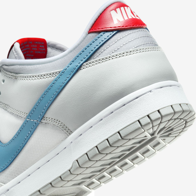 Nike Dunk silver superhero edition 20th anniversary with Flat Silver and Neutral Grey leather, airy textiles, Aegean Storm, and Gym Red accents.