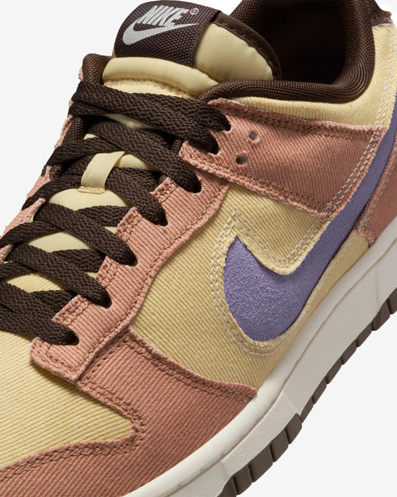 Dunk Low sneaker with iconic color blocking, corduroy layers, and plush padding for comfort and style.