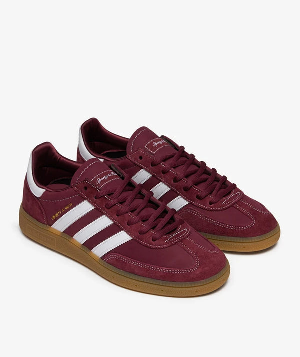 Handball Spezial x Sporty & Rich - Shadow Red sneaker with a suede upper, white 3-Stripes, gold-foil branding, and a gum rubber outsole.