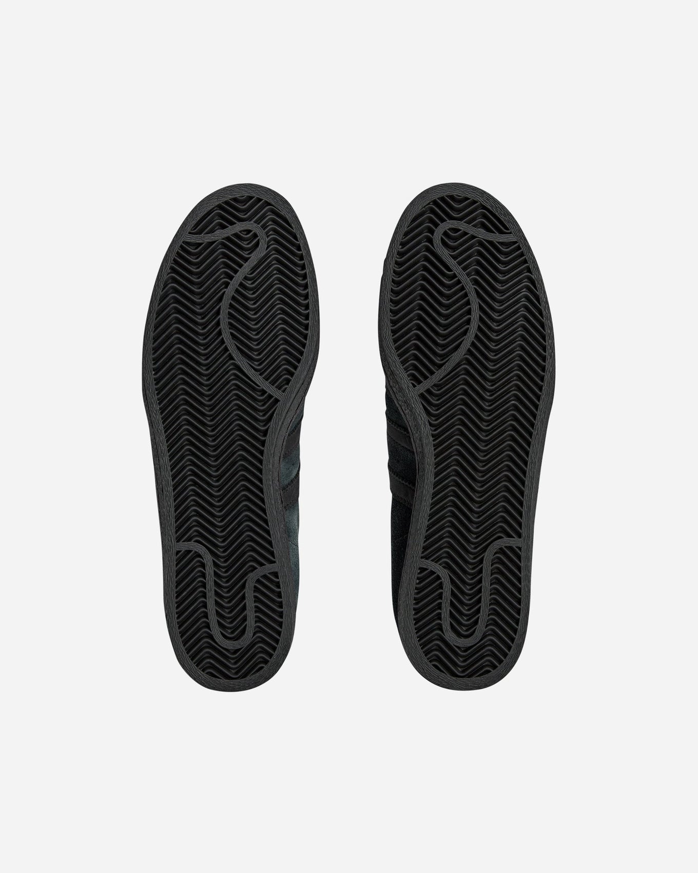 adidas Superstar 82 sneakers with a hand-buffed leather upper, tonal leather shell toe, and waxed laces, inspired by work boots.