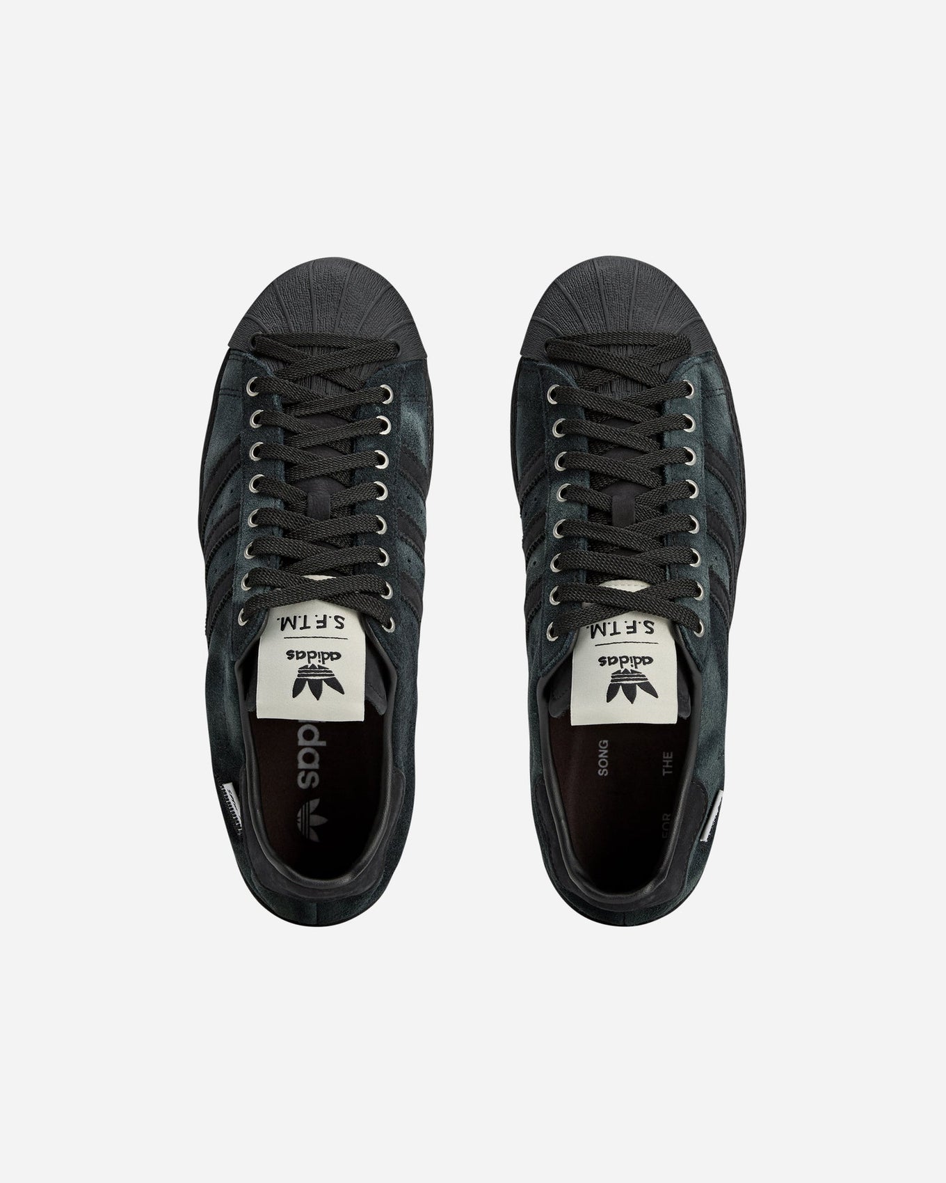 adidas Superstar 82 sneakers with a hand-buffed leather upper, tonal leather shell toe, and waxed laces, inspired by work boots.