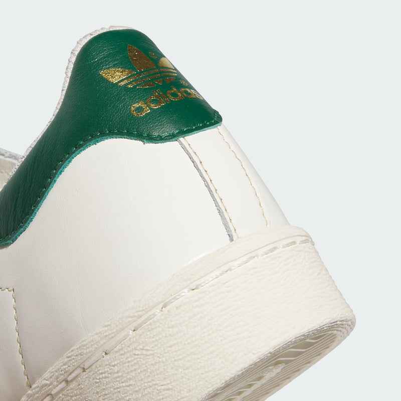 Adidas low-cut leather basketball shoes with rubber outsole, honoring the style of a basketball legend.