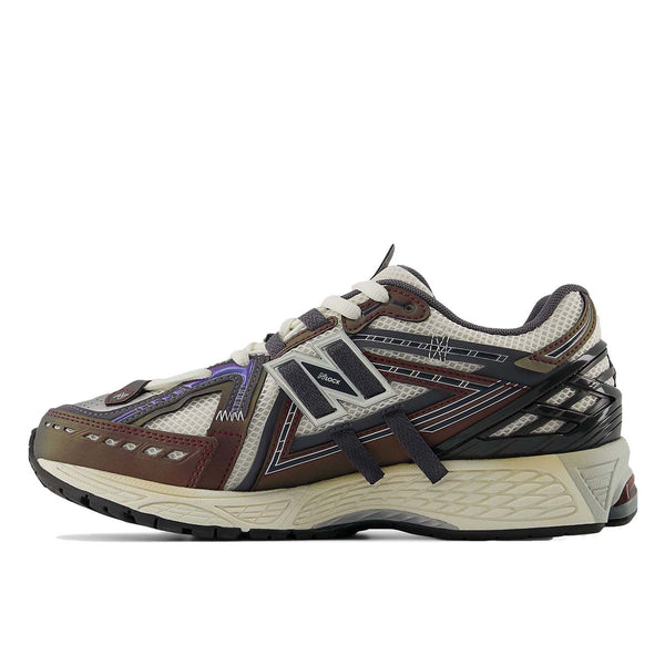 New Balance 1906A sneakers with mesh upper and ABZORB SBS heel cushioning in a retro running silhouette.