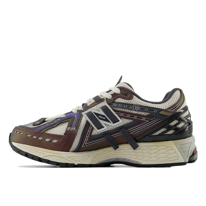 New Balance 1906A sneakers with mesh upper and ABZORB SBS heel cushioning in a retro running silhouette.