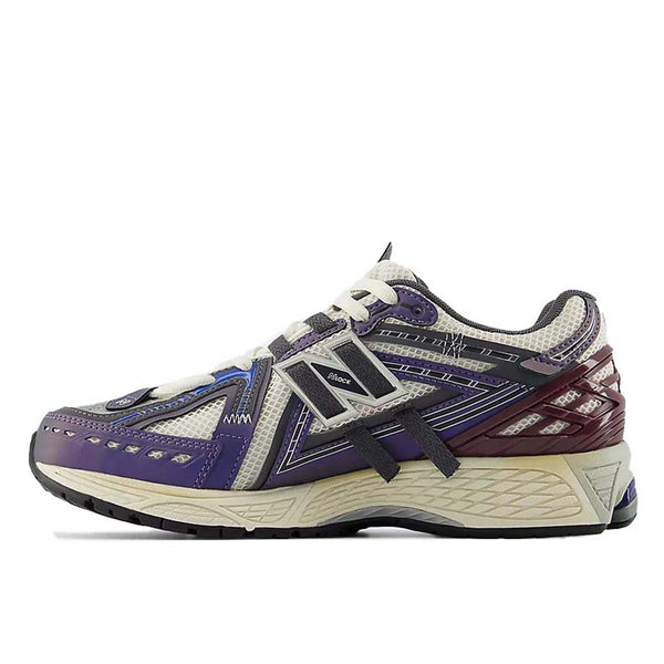 New Balance 1906A sneakers with mesh upper and ABZORB SBS heel cushioning in a retro running silhouette.