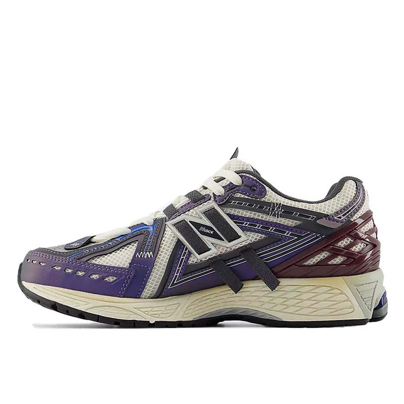 New Balance 1906A sneakers with mesh upper and ABZORB SBS heel cushioning in a retro running silhouette.