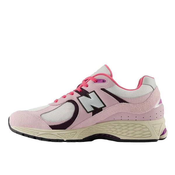 New Balance 2002R sneakers in Passion Fruit and Dragon Berry colorways with suede and mesh upper and ABZORB midsole.
