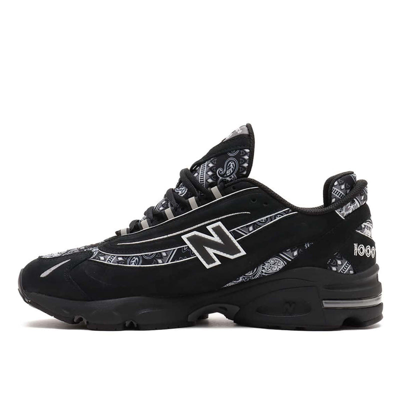 atmos x New Balance M1000 sneakers in black nubuck with bandana pattern details and monochrome color scheme