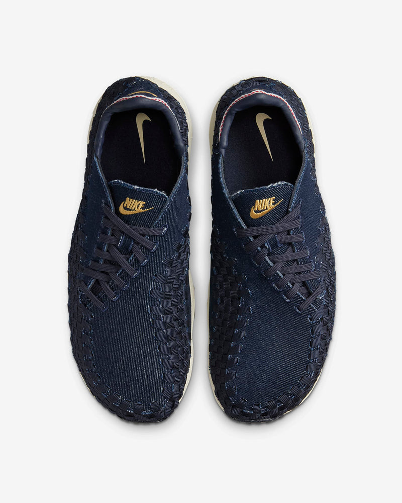 Air Footscape Woven denim sneaker with roomy toe box, lateral lacing, foam midsole, and Nike Air cushioning.