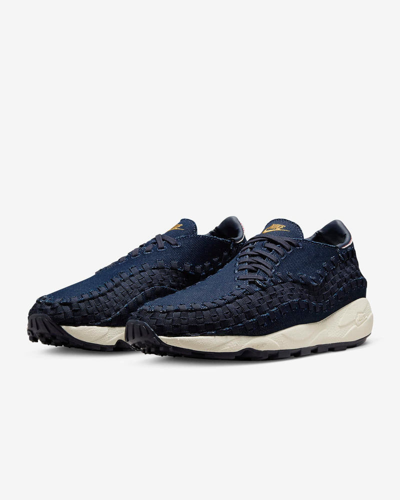 Air Footscape Woven denim sneaker with roomy toe box, lateral lacing, foam midsole, and Nike Air cushioning.