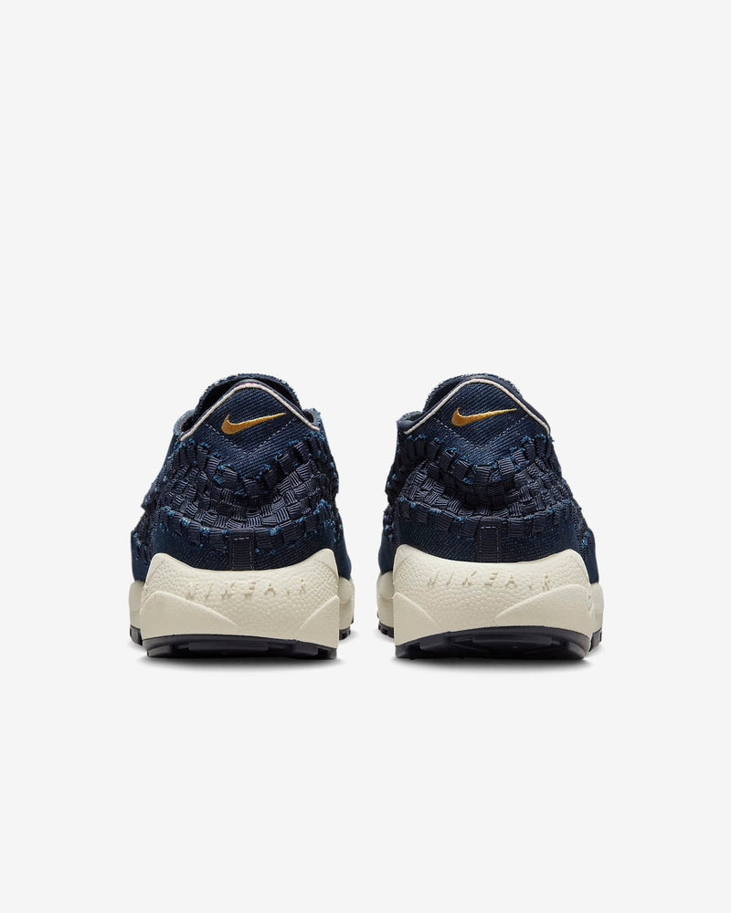 Air Footscape Woven denim sneaker with roomy toe box, lateral lacing, foam midsole, and Nike Air cushioning.