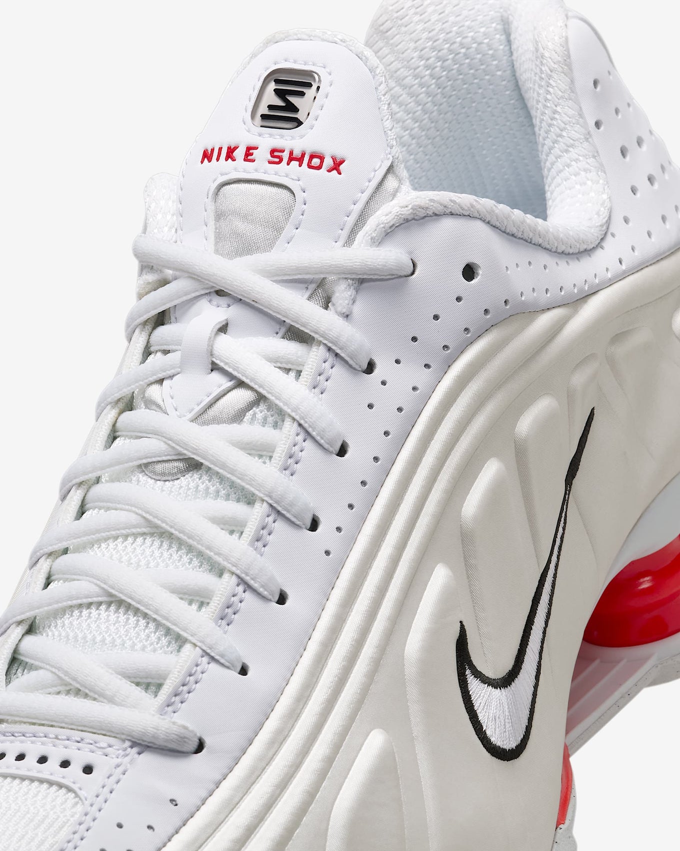 Nike Shox R4 shoes with synthetic and textile upper, laser perforations, and signature Shox cushioning columns in the heel