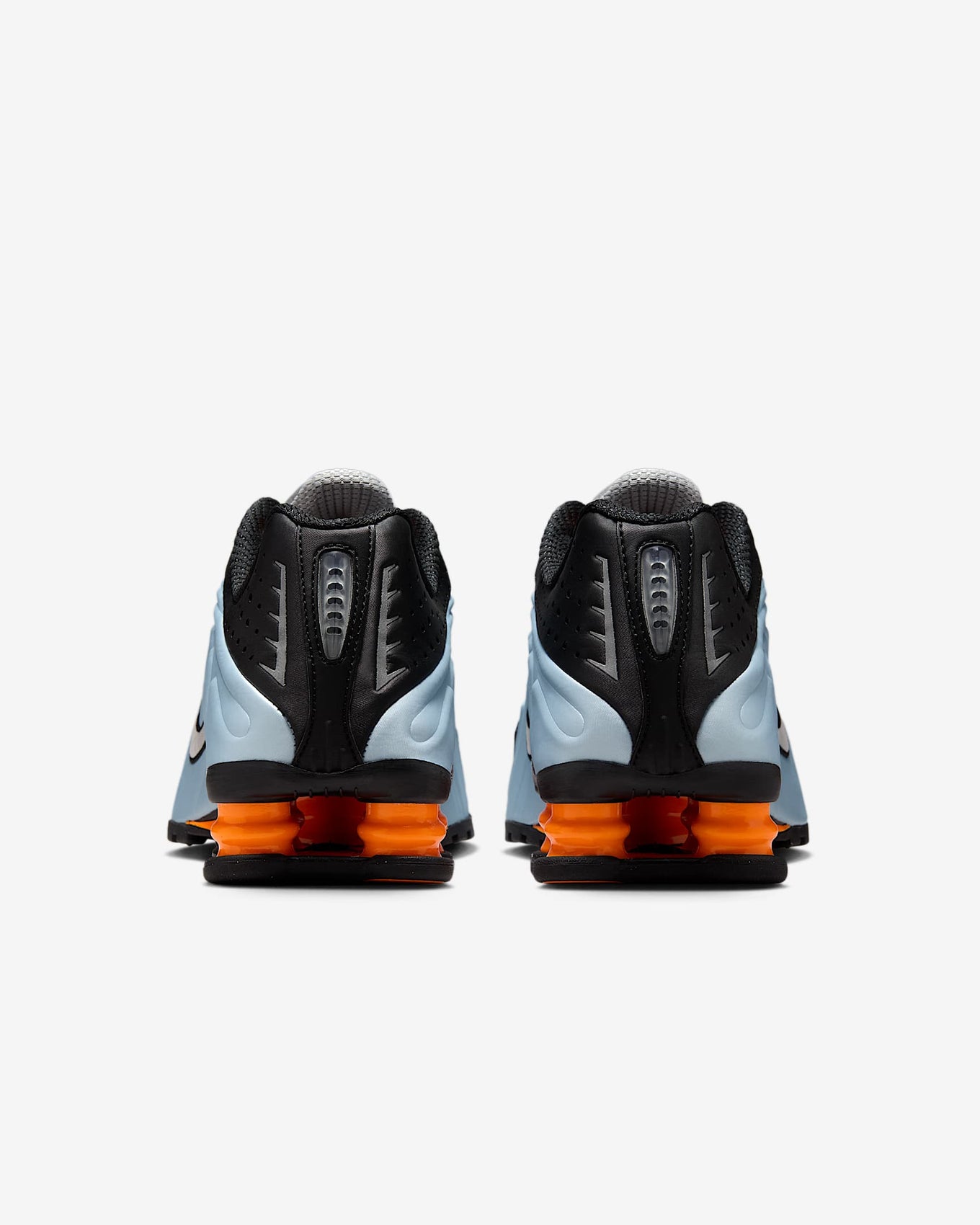 Nike Shox R4 sneakers in silver and red with signature Shox heel cushioning.