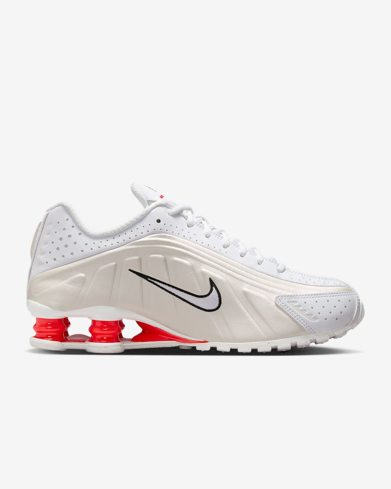 Nike Shox R4 shoes with synthetic and textile upper, laser perforations, and signature Shox cushioning columns in the heel