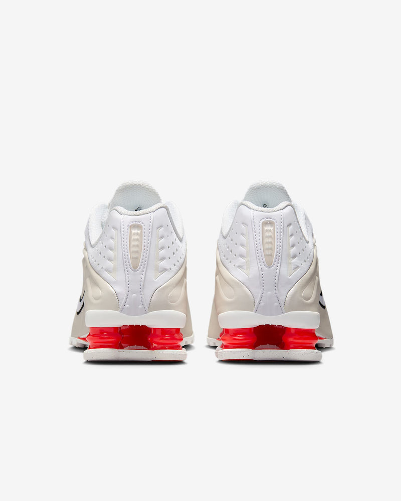 Nike Shox R4 shoes with synthetic and textile upper, laser perforations, and signature Shox cushioning columns in the heel
