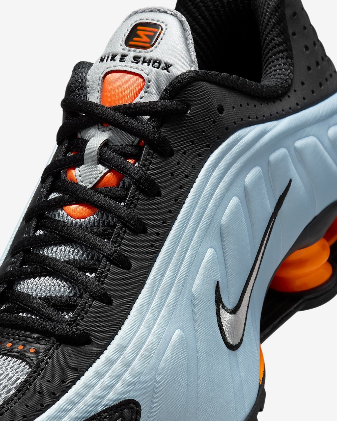 Nike Shox R4 sneakers in silver and red with signature Shox heel cushioning.