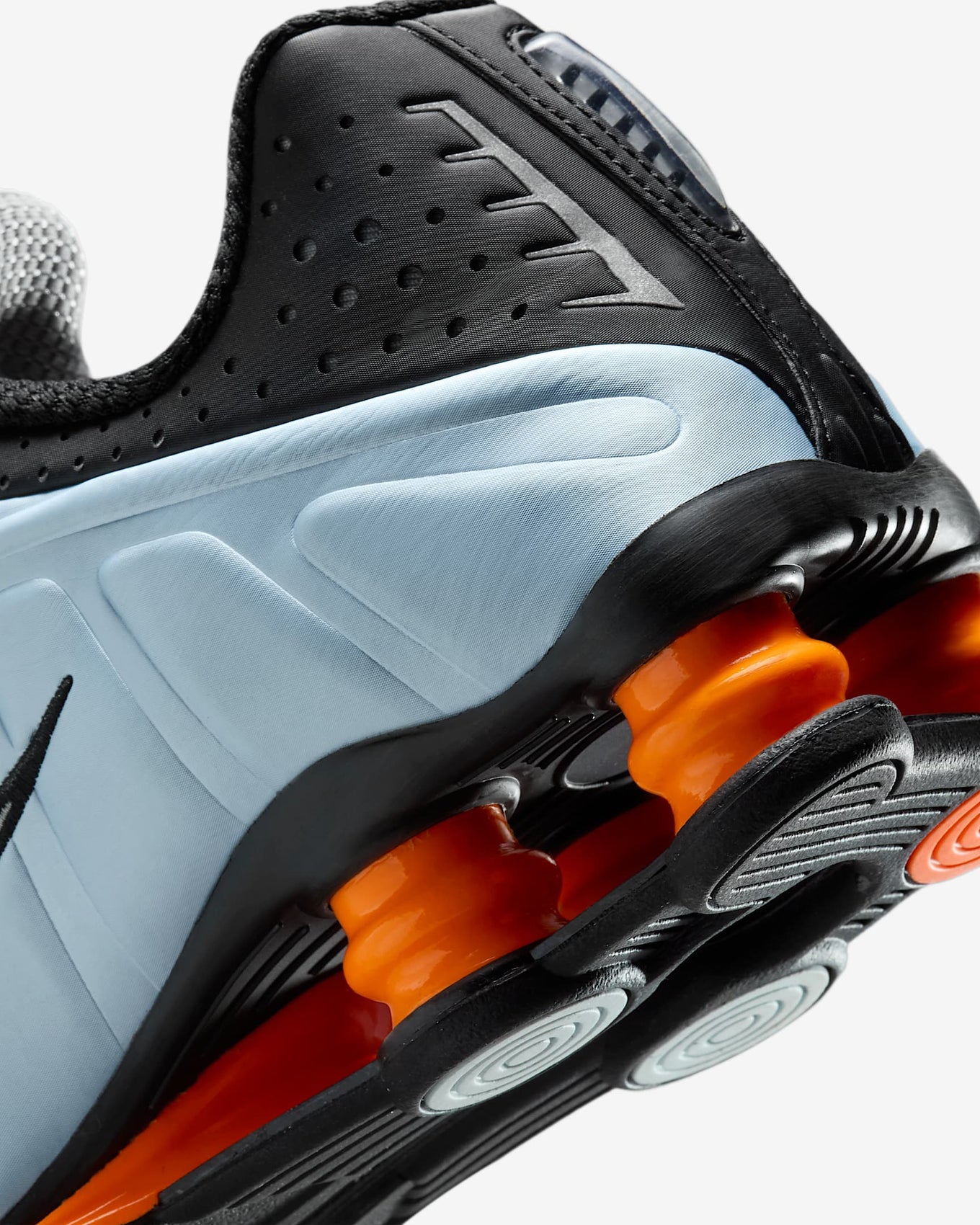 Nike Shox R4 sneakers in silver and red with signature Shox heel cushioning.