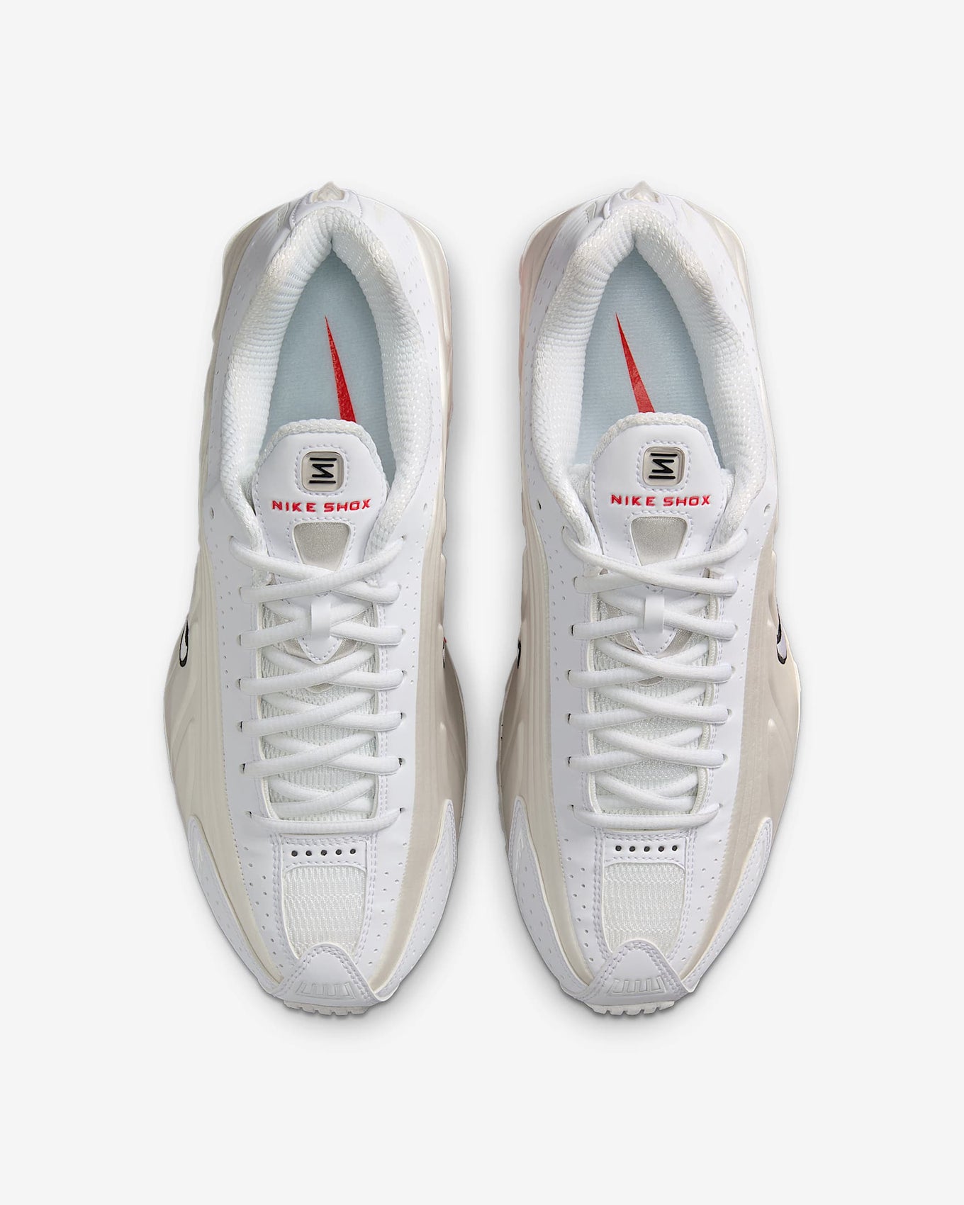 Nike Shox R4 shoes with synthetic and textile upper, laser perforations, and signature Shox cushioning columns in the heel