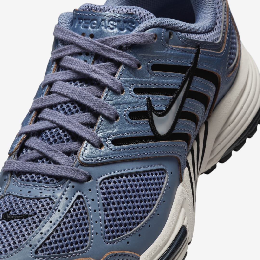 Nike Pegasus 2K5 in Ashen Slate, showcasing subdued palette with earthy accents and raw leather overlays.