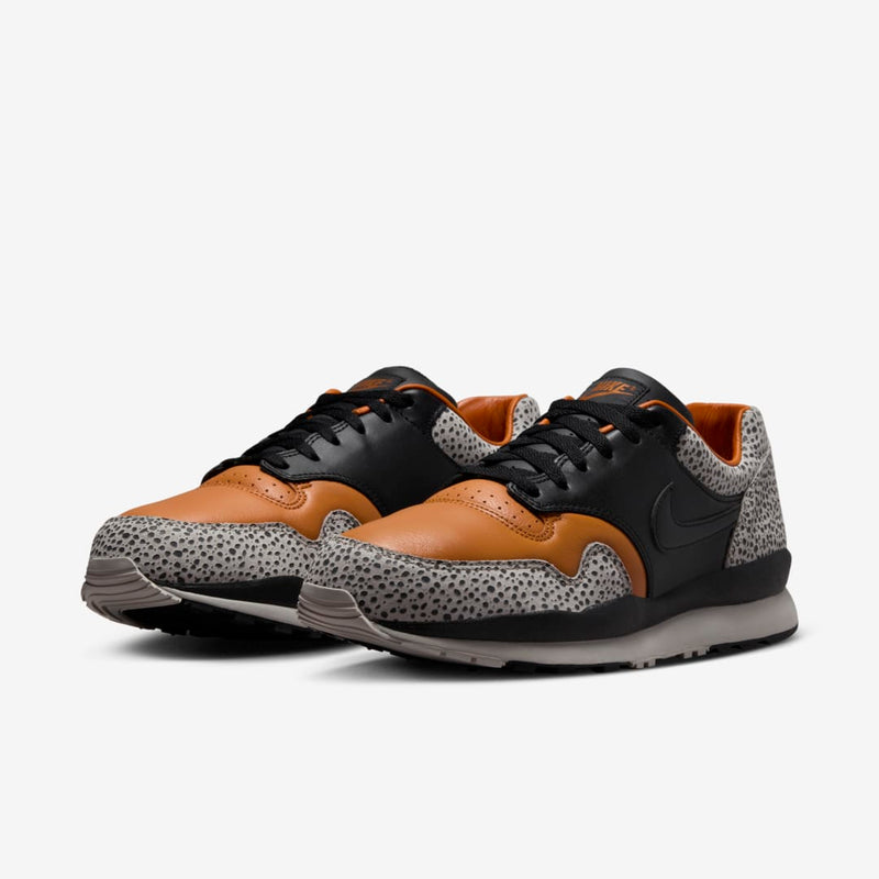 Nike Air Safari OG sneaker with safari print on toe box and heel, black and monarch leather upper, light iron ore midsole, and black rubber outsole


