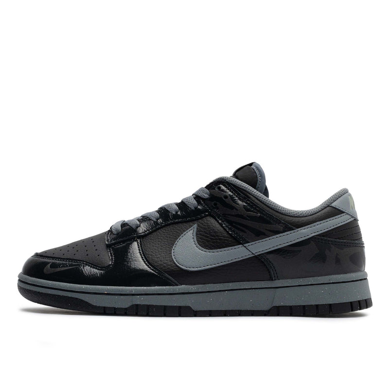 Berlin-inspired Dunk Low sneaker in black and Off-Noir, featuring glossy patent leather accents and reflective tattoo art design on the heel.