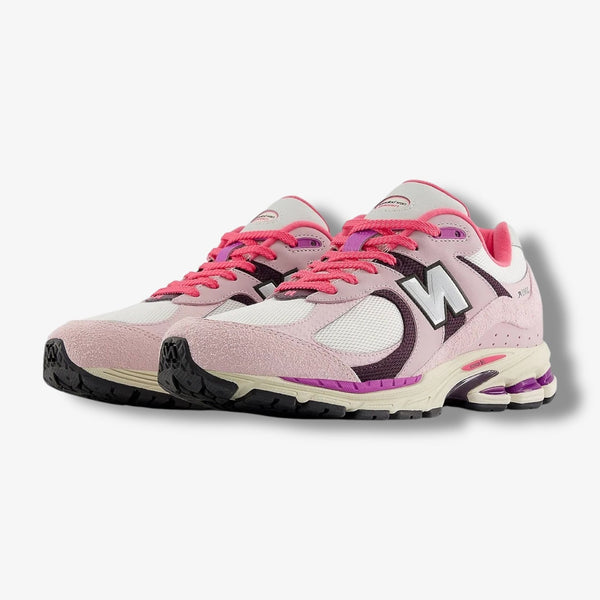 New Balance 2002R sneakers in Passion Fruit and Dragon Berry colorways with suede and mesh upper and ABZORB midsole.