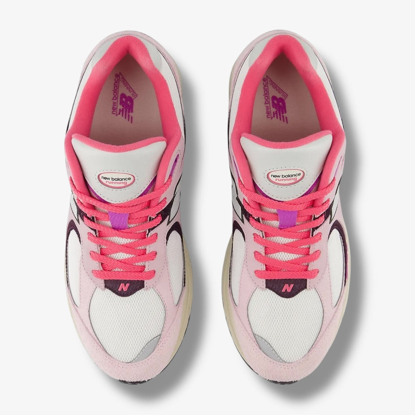 New Balance 2002R sneakers in Passion Fruit and Dragon Berry colorways with suede and mesh upper and ABZORB midsole.