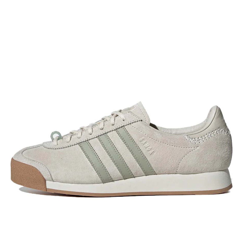 Maha Amsterdam, a prominent women’s streetwear store established in 2015 by Saskia van Hofwegen and Dian Iskandar, collaborates with adidas on the classic sneaker from the late '70s—the adidas Samoa. This design features a low-cut silhouette with a suede upper in "Chalk White," complemented by subtle green accents, comfortable padding, and a cushioned sole. The laces include a jade-colored lace jewel, along with adidas and Maha logo details for added flair.