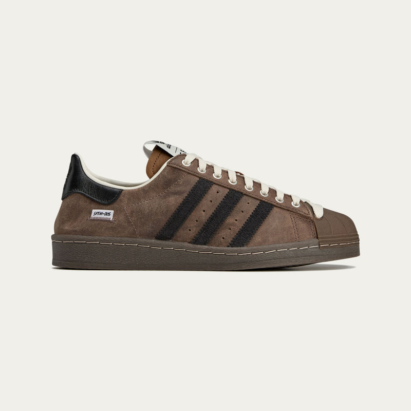 adidas Superstar x Song for the Mute sneakers with a collapsible upper, extended eyelets, and iconic rubber shell toe, blending classic and contemporary design.