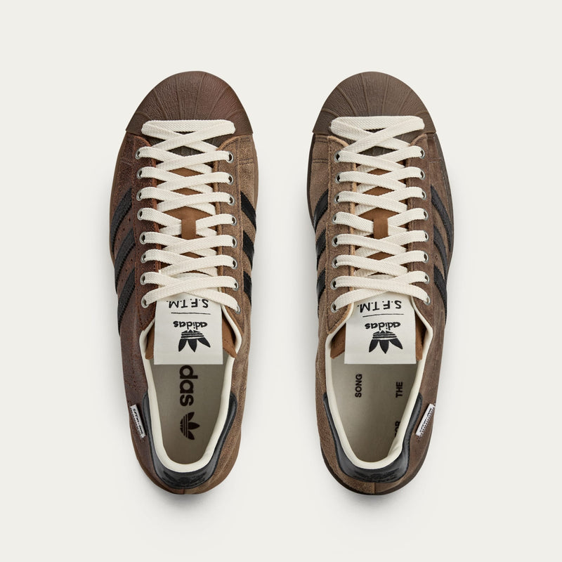 adidas Superstar x Song for the Mute sneakers with a collapsible upper, extended eyelets, and iconic rubber shell toe, blending classic and contemporary design.
