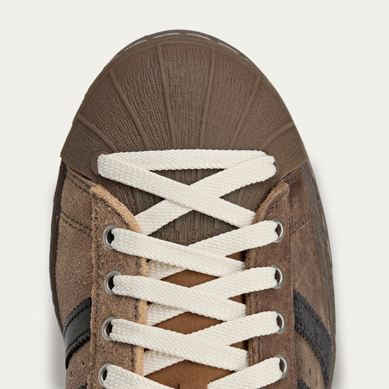adidas Superstar x Song for the Mute sneakers with a collapsible upper, extended eyelets, and iconic rubber shell toe, blending classic and contemporary design.