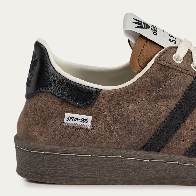 adidas Superstar x Song for the Mute sneakers with a collapsible upper, extended eyelets, and iconic rubber shell toe, blending classic and contemporary design.