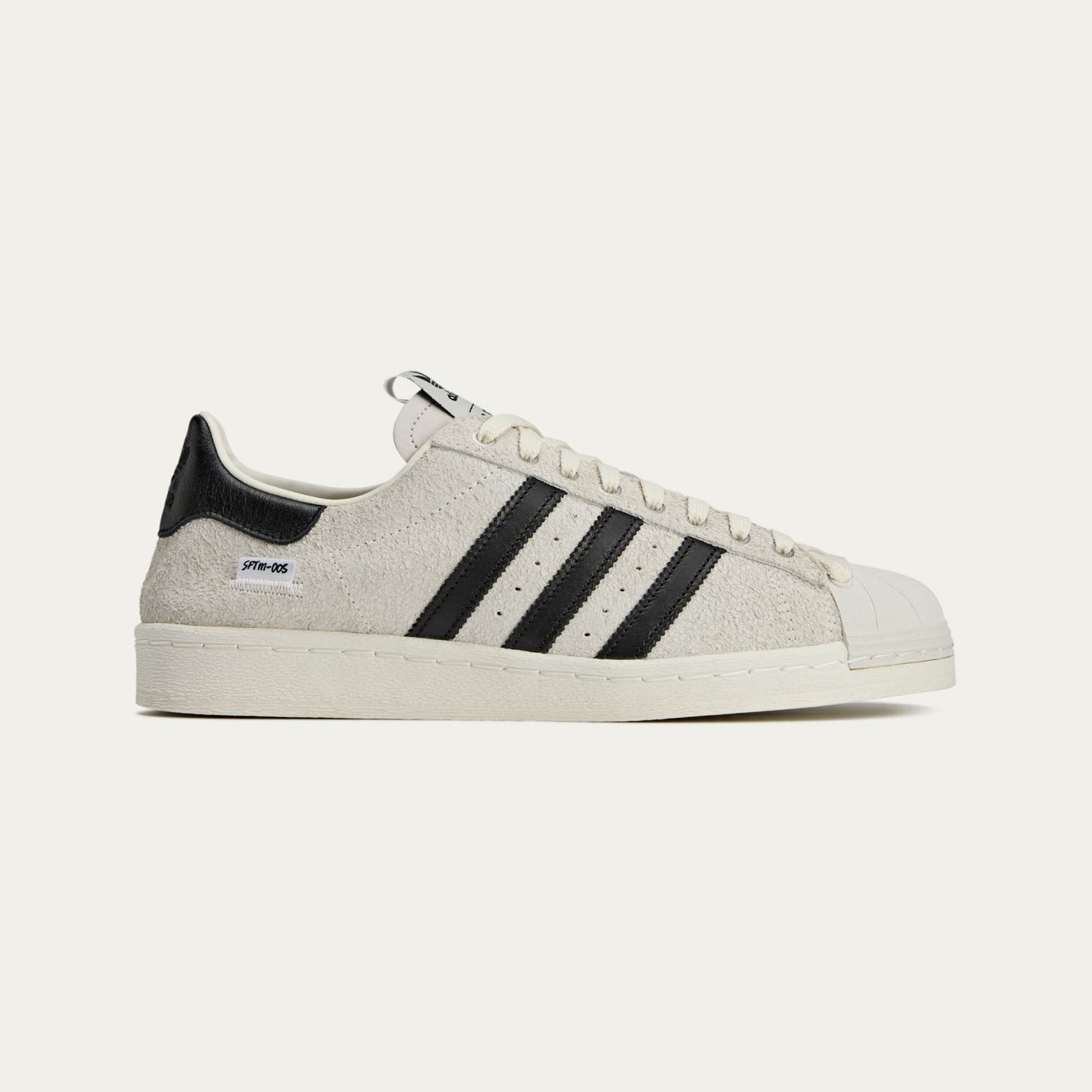 adidas Superstar x Song for the Mute sneakers with a collapsible upper, extended eyelets, and iconic rubber shell toe, blending classic and contemporary design.