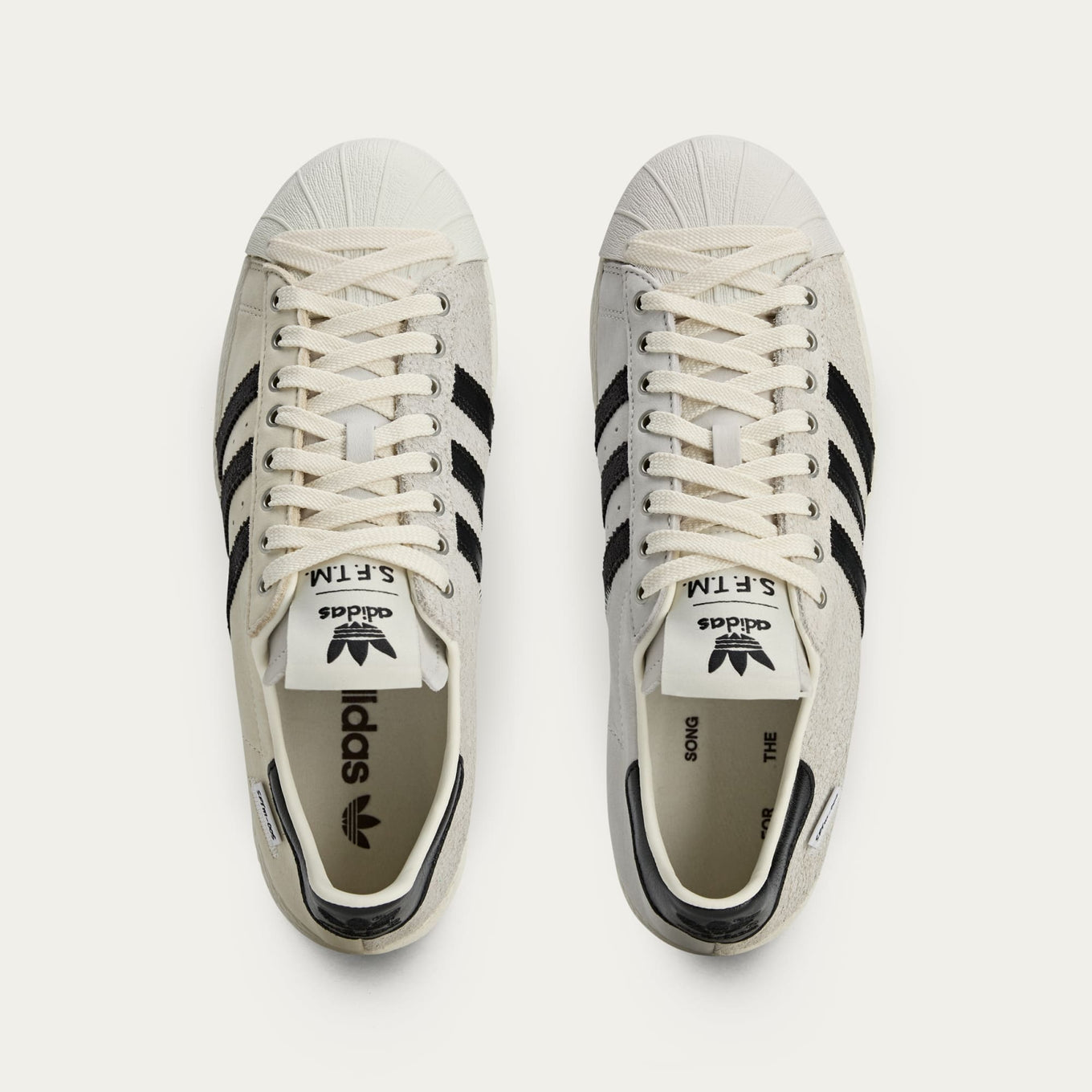 adidas Superstar x Song for the Mute sneakers with a collapsible upper, extended eyelets, and iconic rubber shell toe, blending classic and contemporary design.