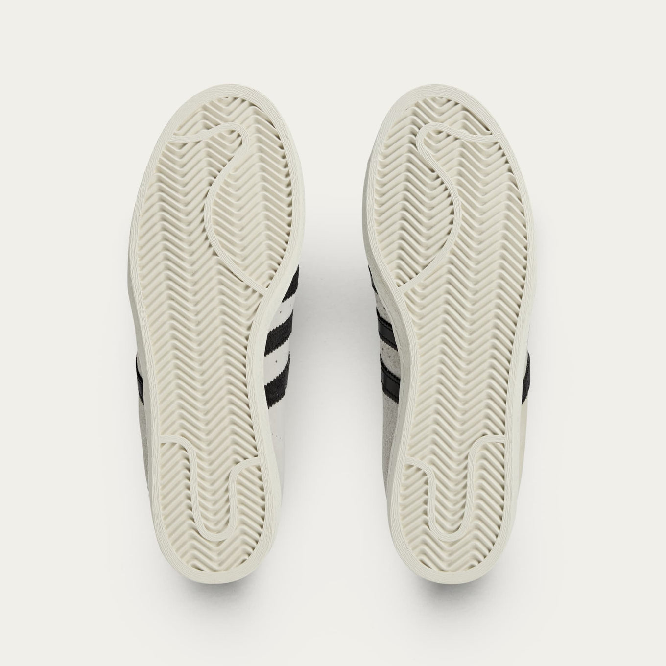 adidas Superstar x Song for the Mute sneakers with a collapsible upper, extended eyelets, and iconic rubber shell toe, blending classic and contemporary design.