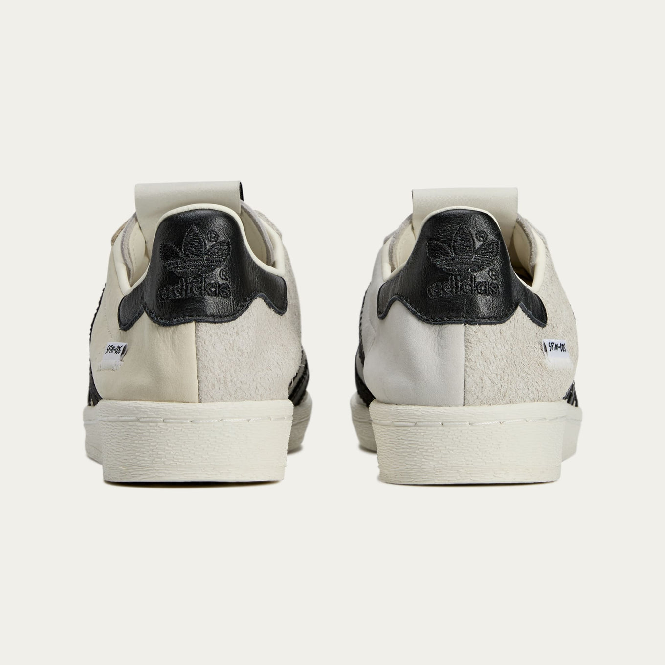 adidas Superstar x Song for the Mute sneakers with a collapsible upper, extended eyelets, and iconic rubber shell toe, blending classic and contemporary design.