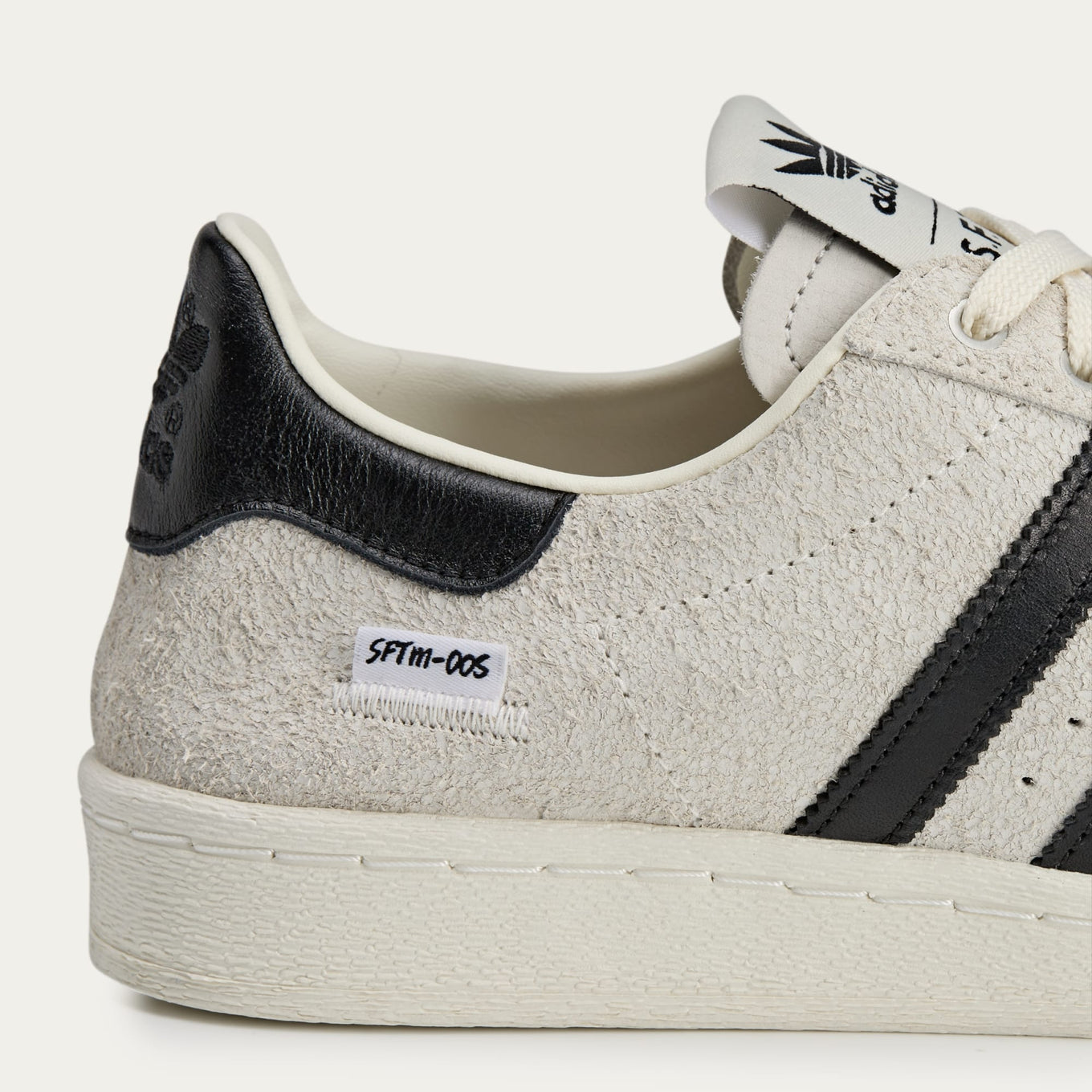 adidas Superstar x Song for the Mute sneakers with a collapsible upper, extended eyelets, and iconic rubber shell toe, blending classic and contemporary design.