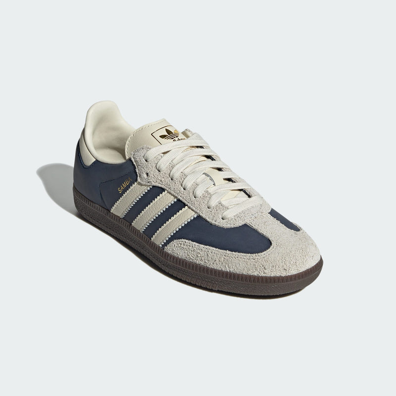 adidas Samba sneakers with premium leather upper, hairy suede accents, and dark gum outsole, showcasing their classic design and gold-printed logo.