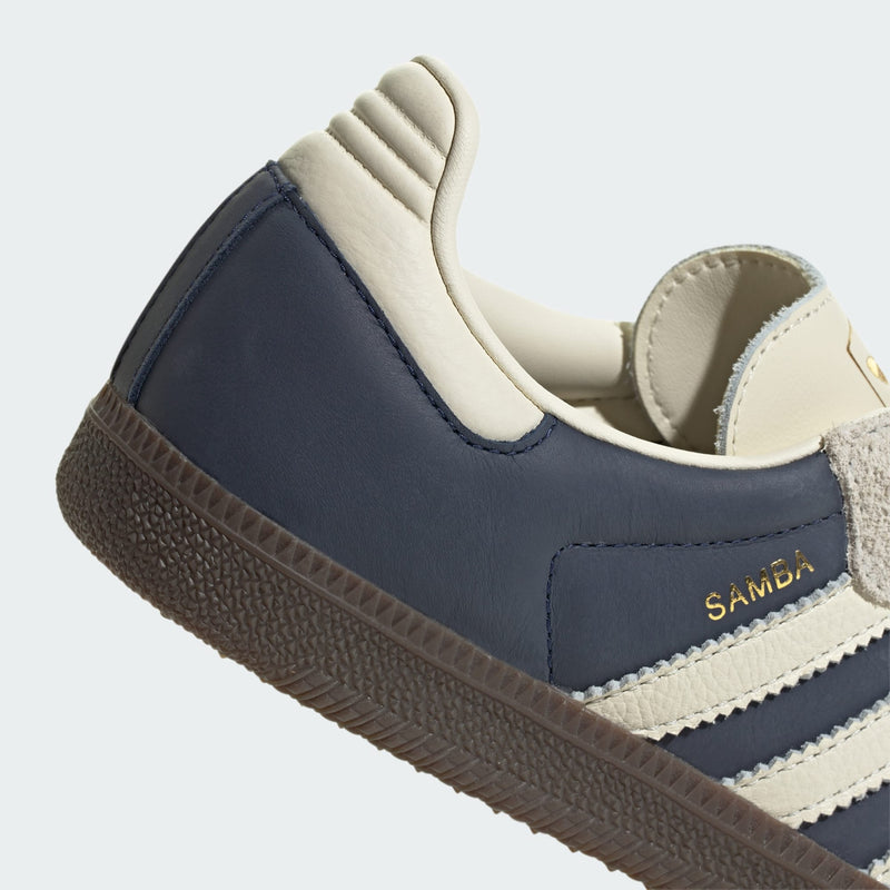 adidas Samba sneakers with premium leather upper, hairy suede accents, and dark gum outsole, showcasing their classic design and gold-printed logo.