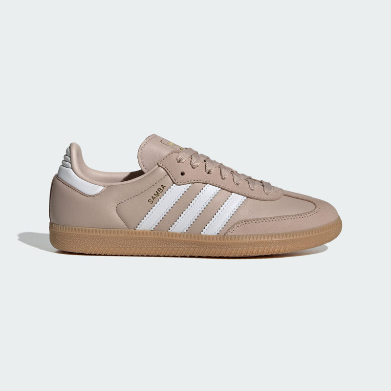 Adidas Samba OG shoes with smooth leather upper and gum rubber outsole, featuring metallic gold accents and serrated 3-Stripes.