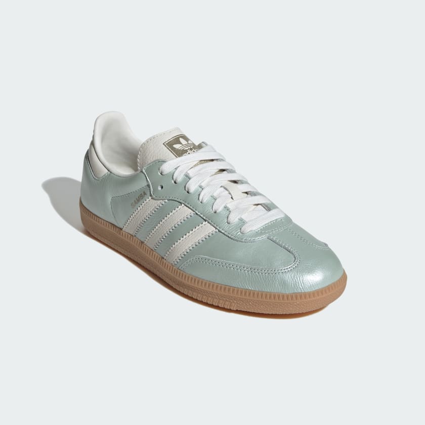 adidas Samba OG shoes with sleek leather upper, durable rubber outsole, and subtle metallic accents.


