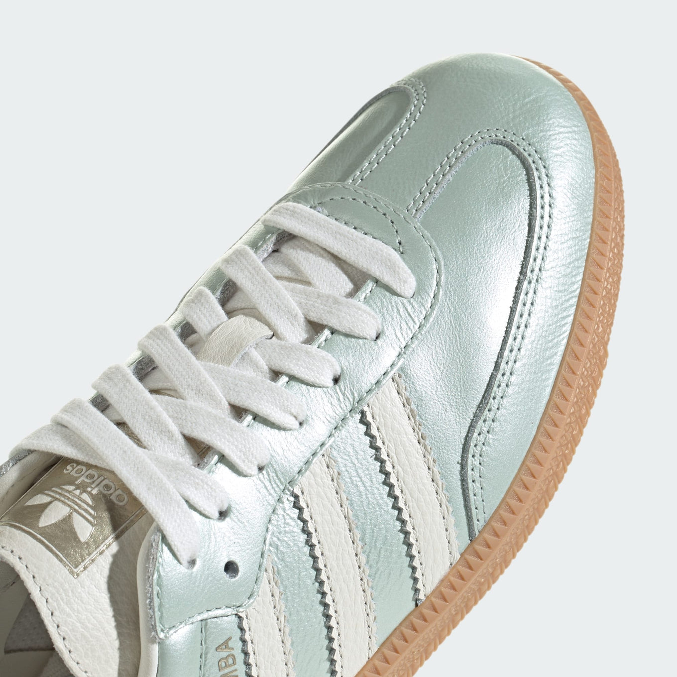 adidas Samba OG shoes with sleek leather upper, durable rubber outsole, and subtle metallic accents.


