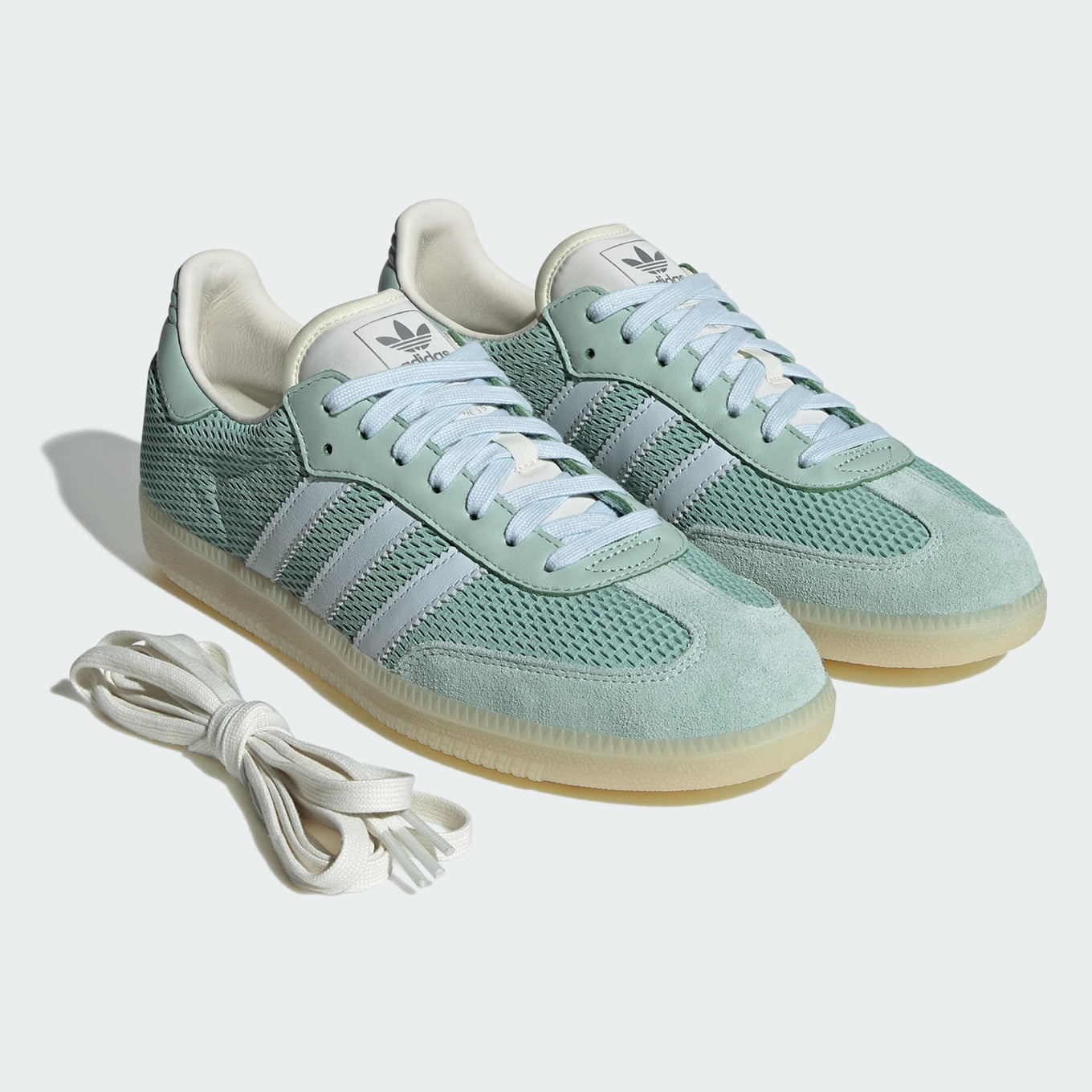 adidas Samba OG sneaker with a mesh-textured leather upper, classic T-toe overlay, and stitched heel tab, embodying vintage style with modern comfort.